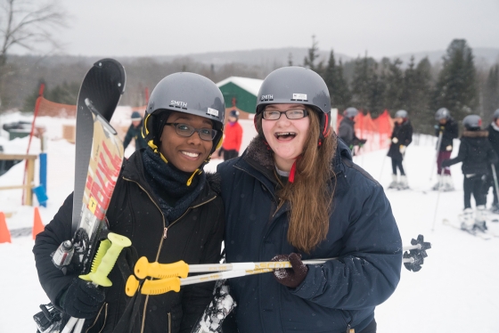 Two skiers holding skis