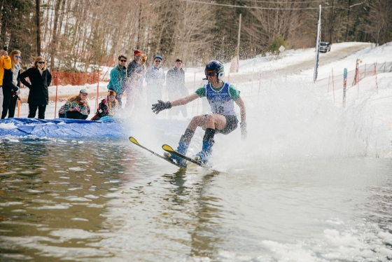 A student skis across a temporary pond at the Dartmouth Skiway