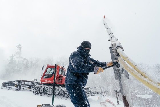 A staff member works on snowmaking equipment at the Dartmouth Skiway