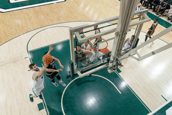 A basketball player shoots a layup
