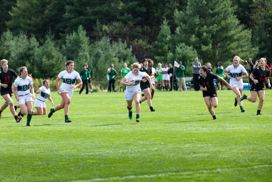 A rugby player runs down the field