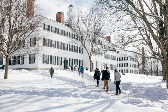 Students walk in front of Dartmouth Hall on a snowy day