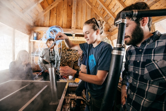 Students and staff at the organic farm boil sap to make maple syrup
