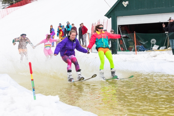 Students take part in the pond skim at the Skiway