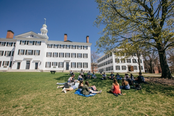 Students attending a class on a sunny spring day in front of Dartmouth Row.