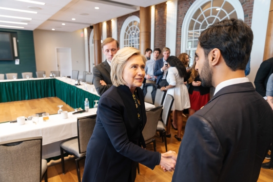 Hillary Rodham Clinton shakes hands with a student