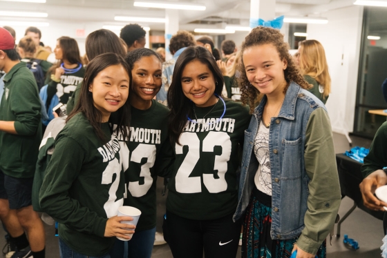 Four First-year students from the Class of 2023 pose at a house event before the start of Dartmouth night. Three of the four are wearing &quot;Class of 2023&quot; shirts.