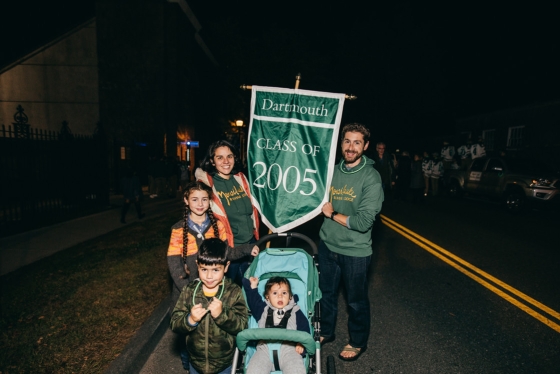 Alumni, including this Class of 2005 family, marched by class year during the parade on Dartmouth Night.