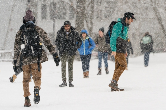 Students walking in many directions during a snow storm
