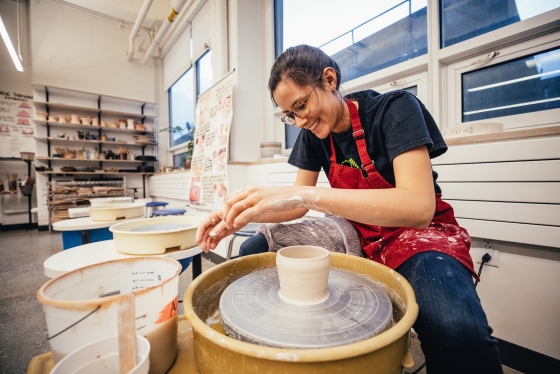 Elizabeth Wallingford, Tuck '20 works on the potter's wheel in the Ceramics Studio in the HOP.