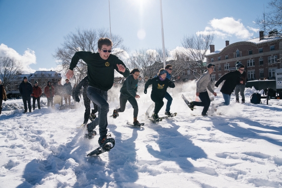 Students run in a snowshoe race at Dartmouth Winter Carnival