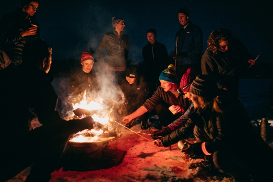 Students enjoy a bonfire after a full moon ski tour at Oak Hill.