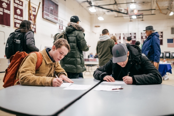 Students fill in their voter registration forms at the Hanover High School