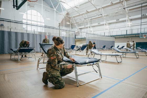 Members of the NH National Guard set up cots in Alumni Gym during the COVID pandemic.