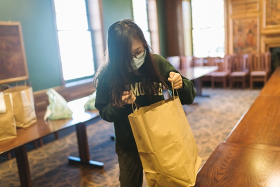 Priscilla Liu '21 picks up her order in Paganucci Lounge in '53 Commons.