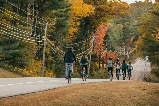 In a single line, on a fall day, students bicycle to the Organic Farm on Rt. 10.