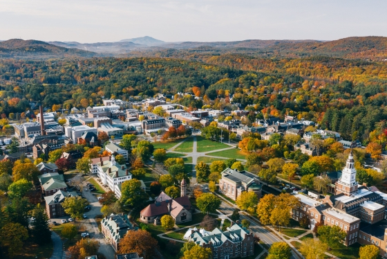 Foliage aerial view of campus, mountains, and hills to the south.