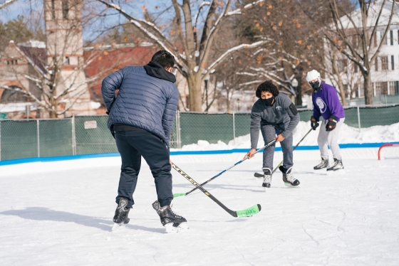 Students playing hockey on the outdoor rinks