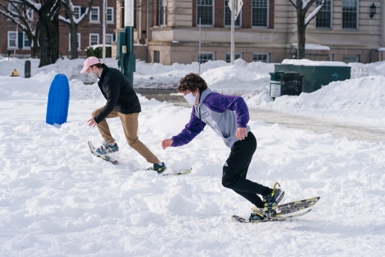 Students snowshoe racing on the Green