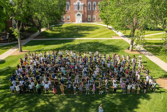 Some members of the Class of 2021 arrange themselves in a socially distant pose on Baker Lawn as they prep for the traditional class photo in a year that has been anything but traditional.
