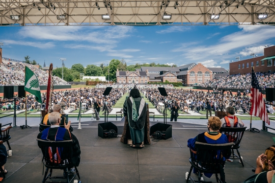 Annette Gordon-Reed on the commencement stage, from the back, overlooking the crowd on Memorial Field