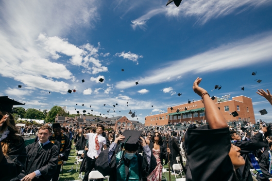 2021 graduates toss their mortarboards into the air on Memorial Field.