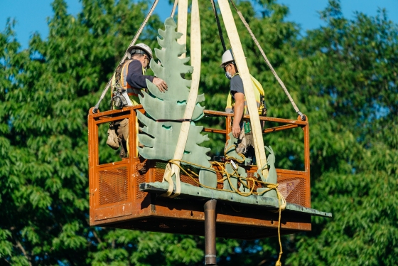 Engineers remove the weathervane from the Baker-Berry Library