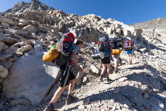 Hikers climbing a rocky trail