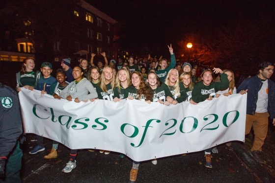 Students from the Class of 2020 carry their class banner on the parade route in 2016. (Photo by Robert Gill)