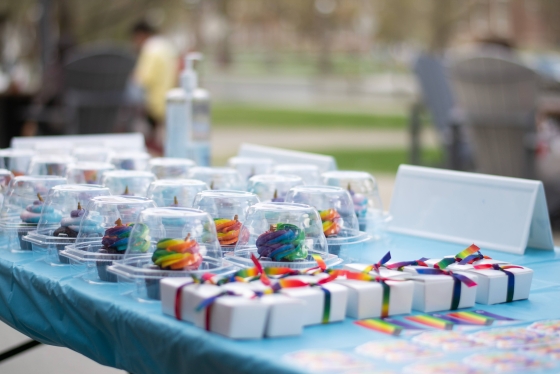 A table full of rainbow Pride Week cupcakes