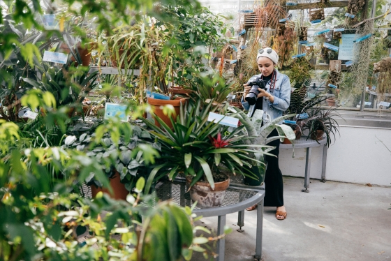 Jumana Khalil, a Dartmouth College-American University of Kuwait Internship Program participant, takes photographs at the Life Sciences Greenhouse.