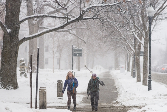 two students walking together in the snow