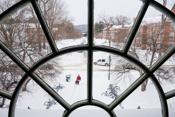 a round window in the library looking out over the Dartmouth Green covered in snow