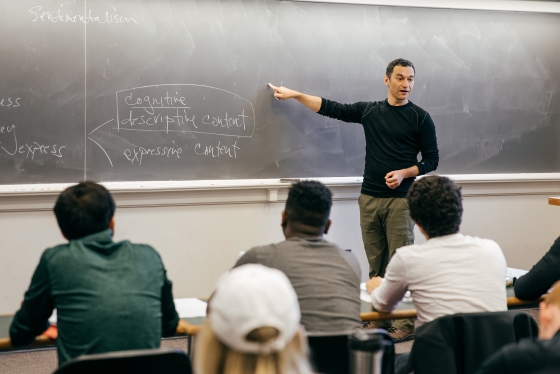 Professor Samuel Levey teaching a philosophy class, standing at a blackboard