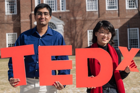 The organizers of TedX Dartmouth hold up cutouts of the letters TEDX