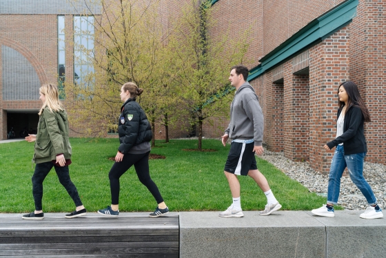 Students walking on a wall