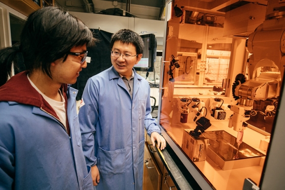 Assistant Professor of Chemistry Chenfeng Ke, right, talks with chemistry graduate student Miao Tang about a 3D printing project Tang designed. Ke is a co-chair of the interdisciplinary 3D printing conference hosted by Dartmouth next week.