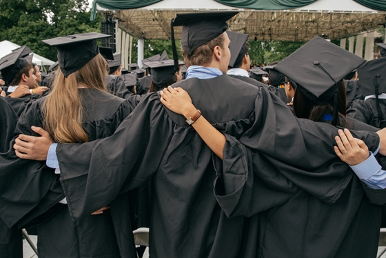 Students hug durring commencement