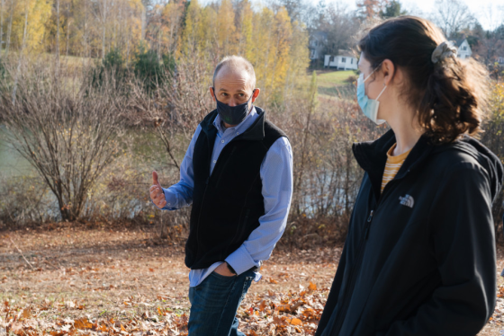 Bill Hudenko, a research assistant professor of psychological and brain sciences, talks with Ariela Feinblum '23 during a weekly walk with students around Occom Pond.