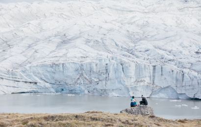 Melissa DeSiervo 'GR and Alex Stendahl '19 sit and observe a glacier in Greenland.