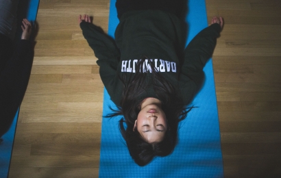 Student lying on a yoga mat