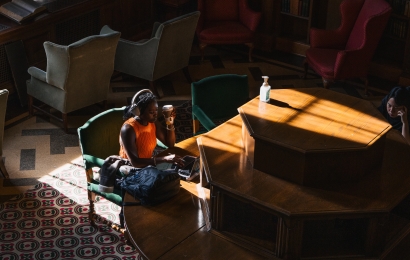 Student at library table studying