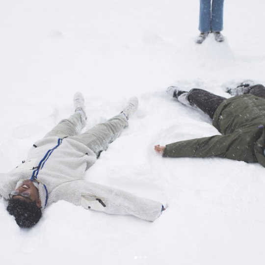 Two students lay in the snow