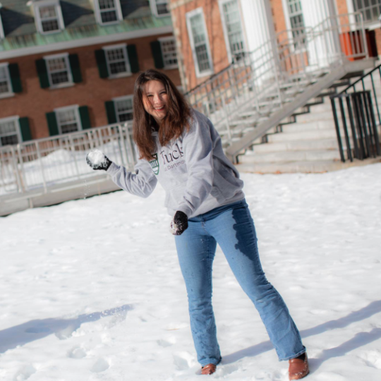 Tuck student holding snowball outside