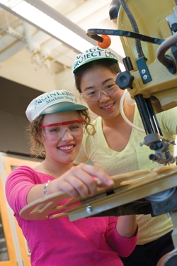 Krystyna Miles ’16, left, and Shinri Kamei ’16, right use Thayer's machine shop