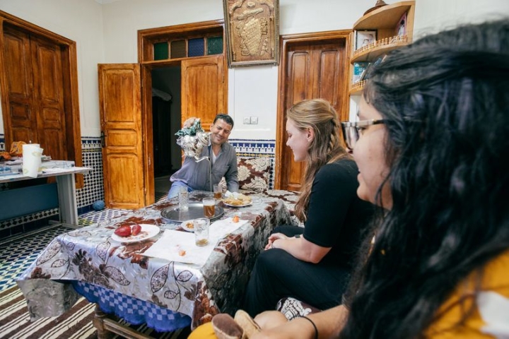 Anisha Ariff ’19 (right) and Juliana Overbey ’19 drink mint tea with their host father.