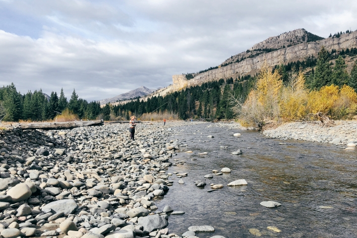 A student fishing in a Wyoming river.