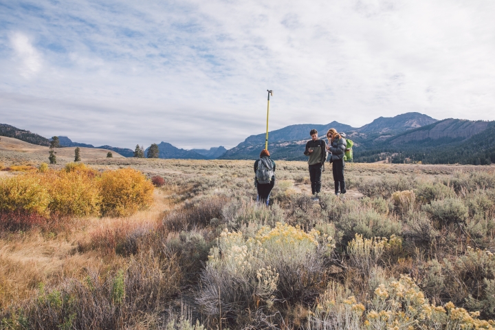 En route to Jackson, Wyo., and Yellowstone, the students stop to practice surveying techniques in a field.