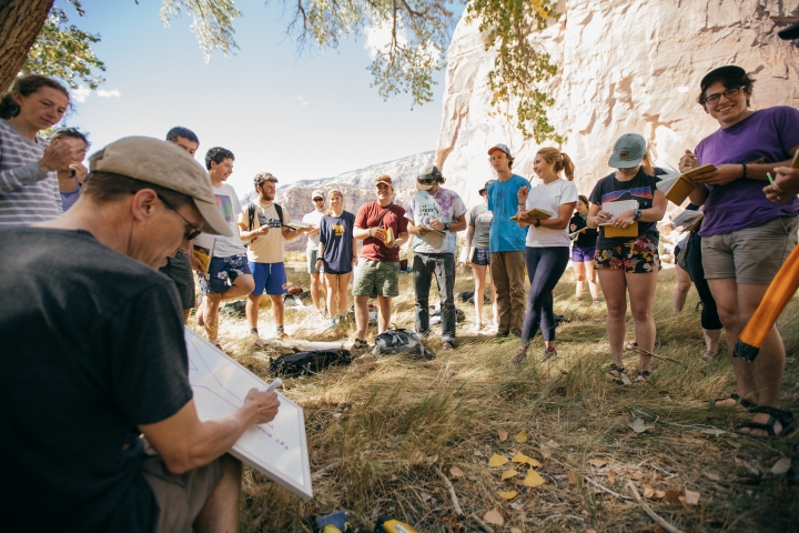 Professor Carl Renshaw explains an assignment while students gather around him in Echo Park.