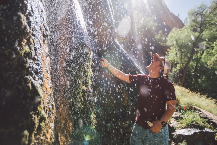Kyle Sullivan ’20 collects a water sample from a waterfall in Zion National Park.